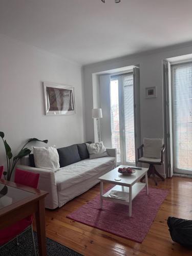 a living room with a couch and a table at Apartamento Lisboa in Lisbon