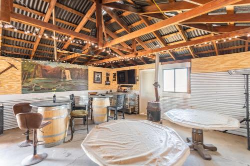 a room with a table and chairs and a bar at Silver Spur Homestead Luxury Glamping -The Miner in Tombstone