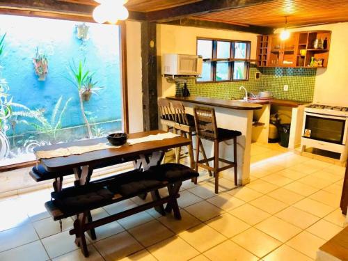 a kitchen with a dining table and an aquarium at Aldeia dos Encantos Inn in Arraial d'Ajuda