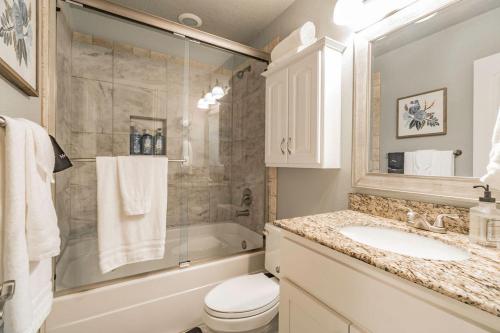 a bathroom with a sink and a toilet and a shower at ROYAL LANDING 3BD MTB Friendly in Bentonville