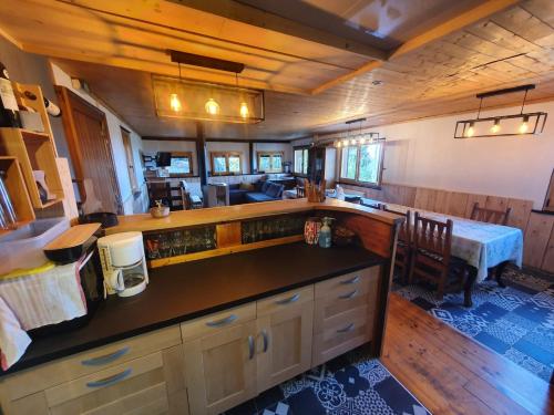 a room with a kitchen and a dining room at Chalet ALOA in Le Bonhomme