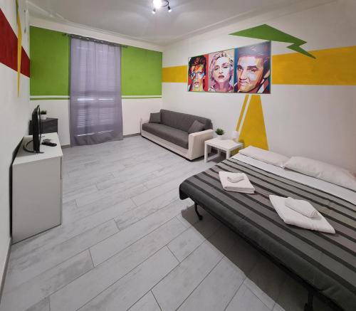 a bedroom with a bed and a couch in it at APT Re di Roma in Rome