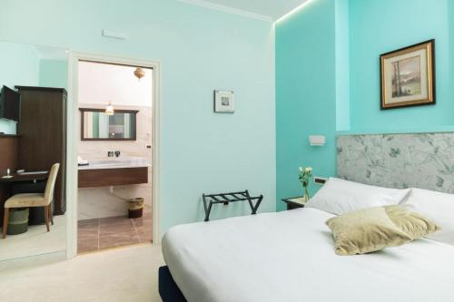 a bedroom with a bed and a bathroom with a sink at Le Corti - Dimora storica in Polistena