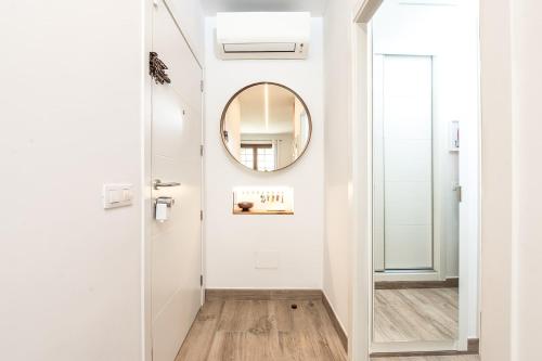 a hallway with a door and a mirror at Magec Santa Cruz in Santa Cruz de Tenerife