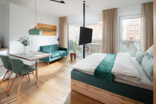 a bedroom with a bed and a living room at Haus Noena - Wohnung 7 Inselschatz in Norderney