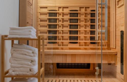 a room with a rack of towels and a fireplace at Villa Rita Heritage Villas in Kaštela