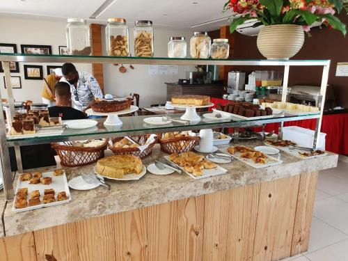 a buffet line with a lot of food on it at Angra Praia Hotel in Fortaleza