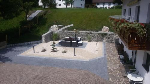 an aerial view of a patio with a couch and a table at Gästehaus Hosp in Reutte