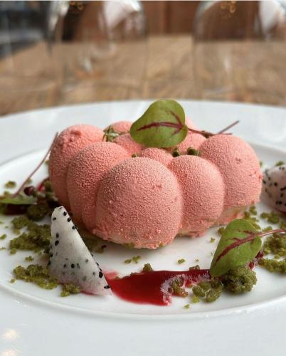 a white plate with a dessert on a table at Hôtel du Musée in Granville