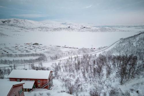 a barn in a field covered in snow at Ski in ski out lägenhet med fantastisk utsikt in Riksgränsen