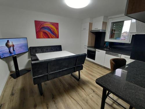 a living room with a couch and a kitchen at Butthouse Apartments in Trimbach