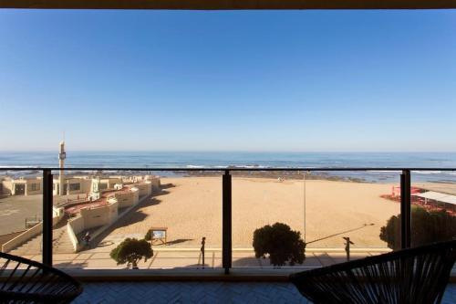 a view of the beach from the balcony of a condo at Boutique Rentals- AL MAR Beachfront in Póvoa de Varzim