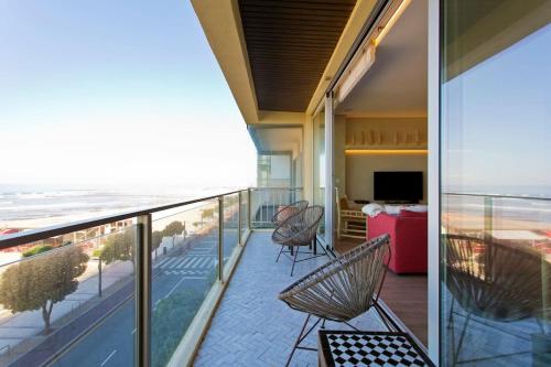 a balcony with chairs and a view of the beach at Boutique Rentals- AL MAR Beachfront in Póvoa de Varzim