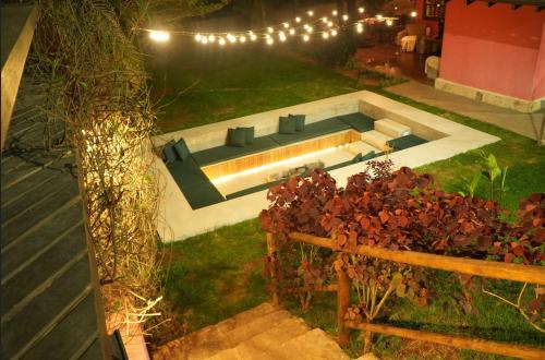 a backyard with a swimming pool at night at Pousada Golf Village in Itaipava