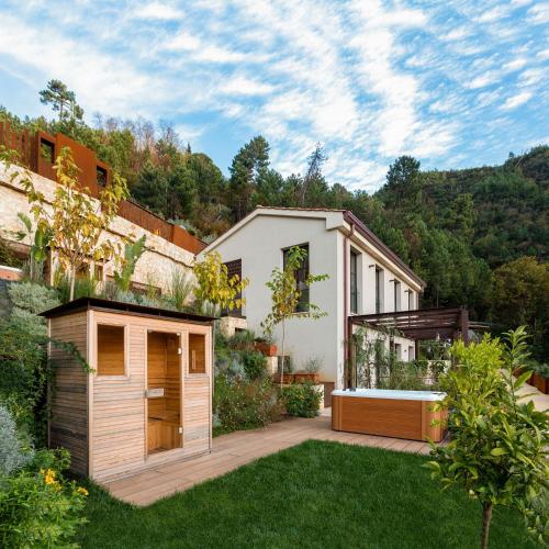 a house with a garden in the middle of a yard at Tenuta Zamparina in Montignoso
