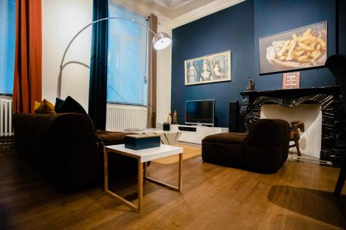 a living room with two couches and a fireplace at GITADIN - Deluxe Suite Rousseau - Historical center in Liège