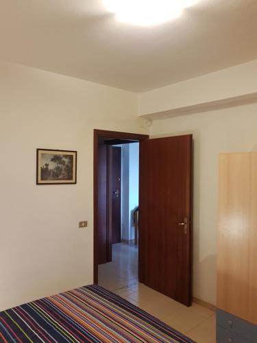 an empty room with a door and a hallway at SANT'ALESSIO_BAY in Santa Margherita-Sant'Alessio Siculo