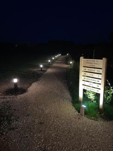 a row of lights on a road at night at Wimbish Hall Cabins in Wimbish