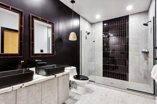 a bathroom with a sink and a toilet and a shower at Nova Rooftop Villa in New Orleans