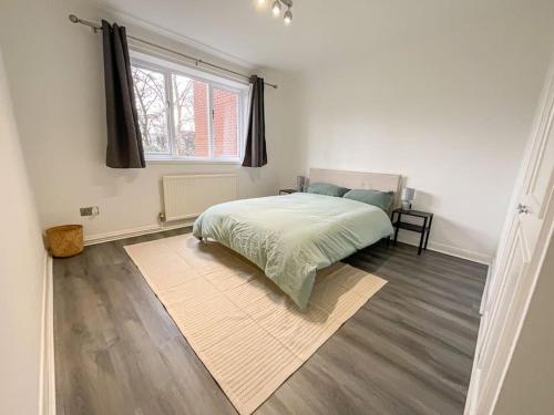 a white bedroom with a bed and a window at 49 Saxon Mill, Tamworth in Tamworth