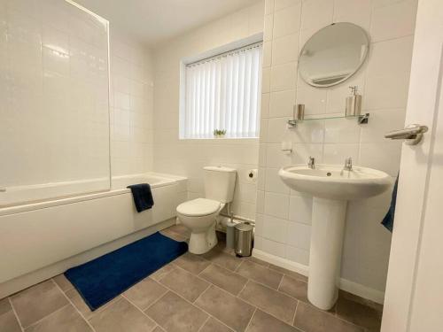 a white bathroom with a sink and a toilet at 49 Saxon Mill, Tamworth in Tamworth