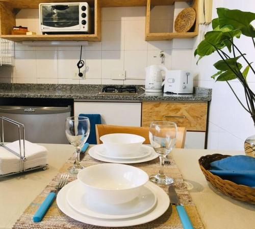 a table with plates and glasses on a kitchen counter at Tu Paraíso Urbano in Buenos Aires