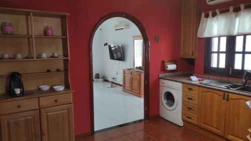 a kitchen with an archway and a washing machine at CASA GUELDE in Tías
