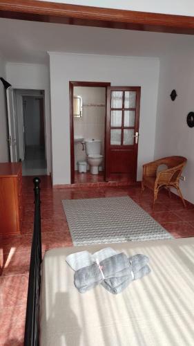 a bedroom with a bed with two towels on it at CASA GUELDE in Tías