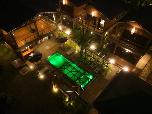 an overhead view of a house with a pool at night at Barong EcoVilla in Barra Grande