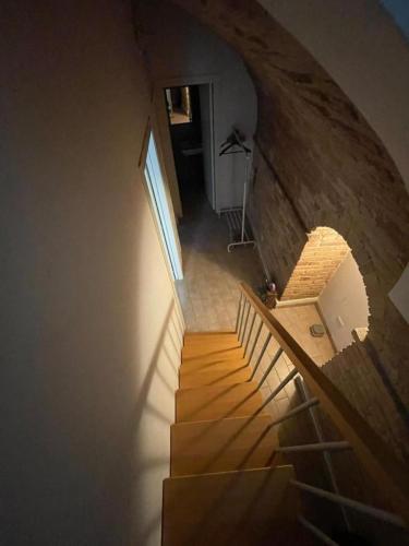 a staircase in a house with a brick wall at Il Duomo 3 in Osimo