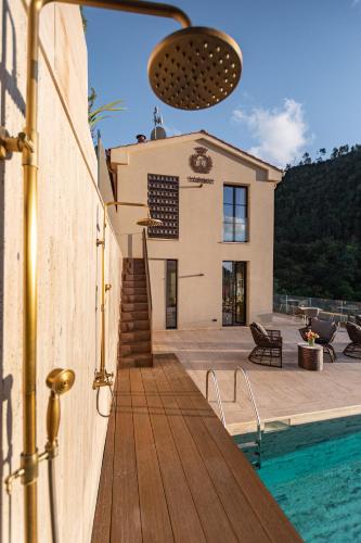 a house with a swimming pool next to a house at Tenuta Zamparina in Montignoso