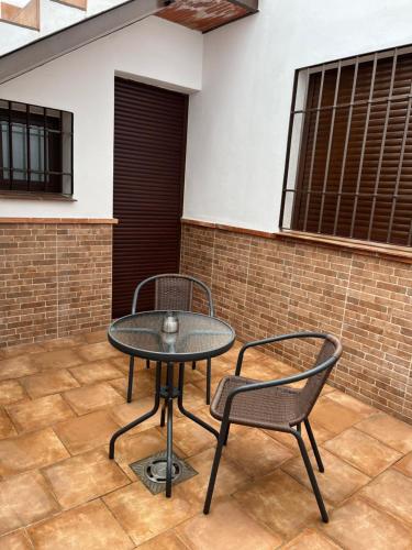 a table and two chairs on a patio at CASA MARTÍN in Hornachuelos