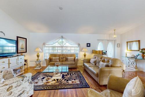 a living room with two couches and a tv at Buttercream Villa in Biggar