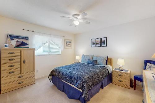 a bedroom with a bed and a dresser and a window at Buttercream Villa in Biggar