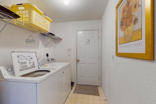a white laundry room with a washing machine in it at Buttercream Villa in Biggar