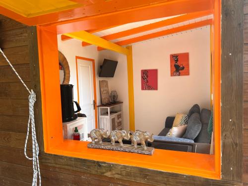 a mirror in a living room with a couch at Kazavocat in Gourbeyre