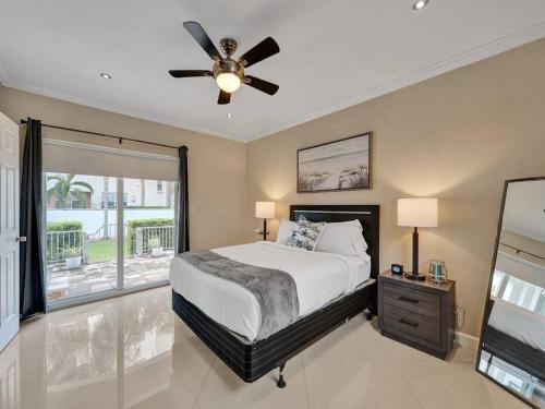 a bedroom with a bed and a ceiling fan at Beach Isles Modern 1BR in Fort Lauderdale with Patio in Fort Lauderdale