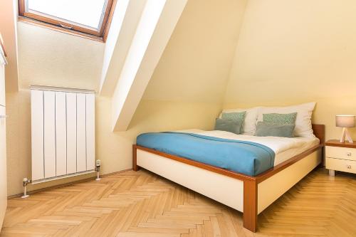 a small bedroom with a bed in the attic at Hotel Katerina in Znojmo