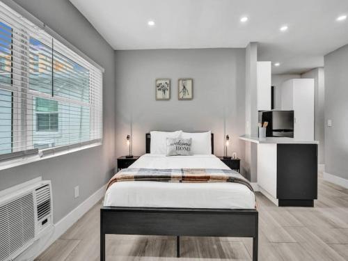 a bedroom with a bed and a large window at Coastal Charm Studio Retreat near Pompano Beach in Pompano Beach