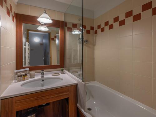 a bathroom with a sink and a tub and a mirror at Appartement Val Thorens, 1 pièce, 4 personnes - FR-1-640-53 in Val Thorens