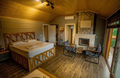 a bedroom with a large bed and a fireplace at Taş Mahall Luxury Hotel in Sile