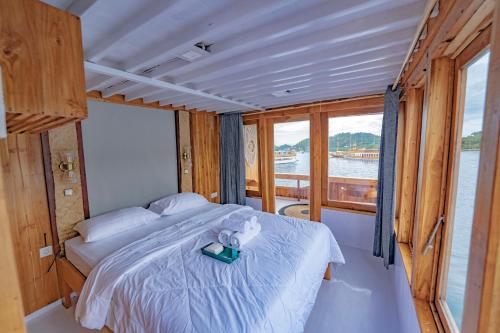a bedroom with a bed with a teddy bear on it at Phinisi Boat Maheswari Komodo in Labuan Bajo