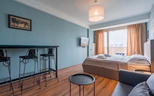 a bedroom with a bed and a living room at Kudebi apartments, Twins new Gudauri in Gudauri