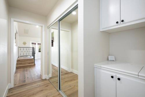 a kitchen with white cabinets and a glass door at Beautiful Spacious Home in Los Angeles