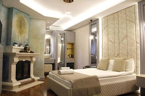 a bedroom with a large bed and a fireplace at Cadde 7 Otel in Ankara