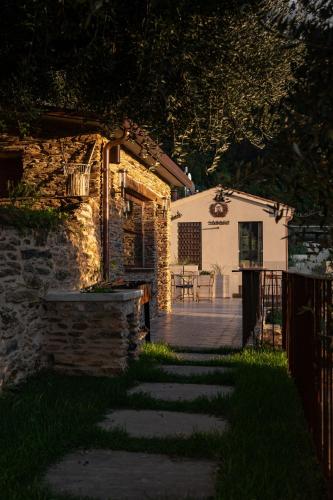 a backyard with a stone building and a patio at Tenuta Zamparina in Montignoso