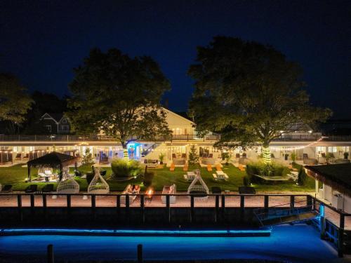 a view of the inn from the water at night at Aqua by American Beech - Adults Only in Aquebogue