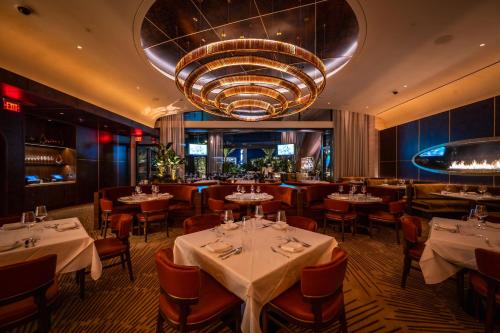 a restaurant with tables and chairs and a large chandelier at Durango Casino & Resort in Las Vegas