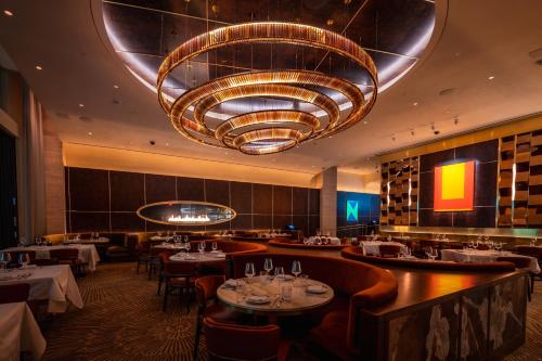 a dining room with tables and a large chandelier at Durango Casino & Resort in Las Vegas