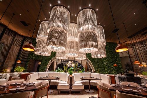 a restaurant with a large chandelier and tables and chairs at Durango Casino & Resort in Las Vegas